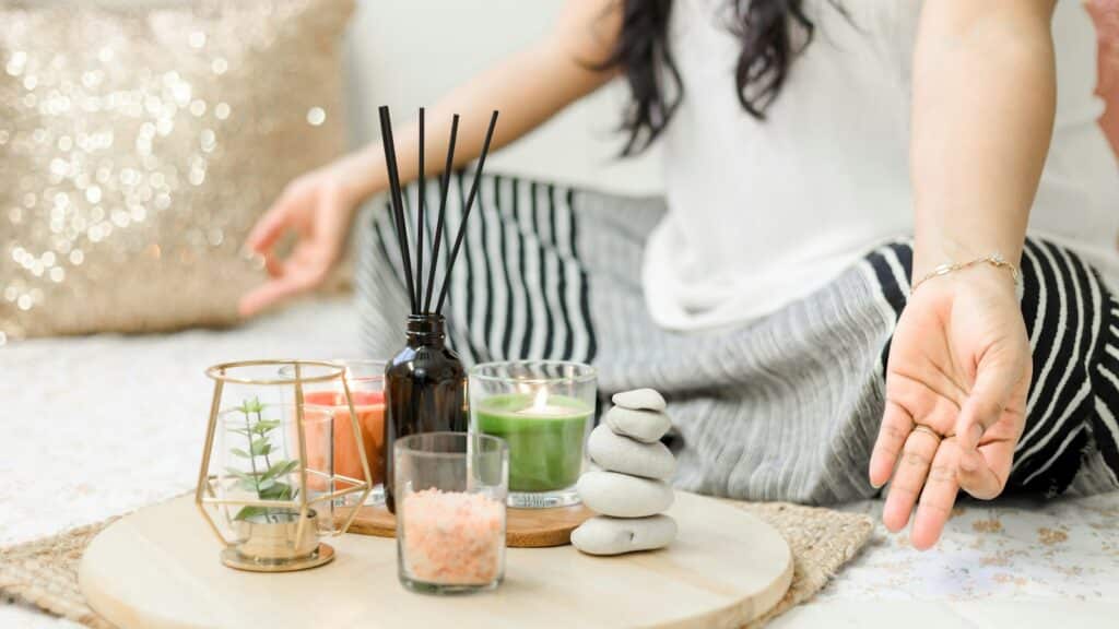 woman in white tank top holding black chopsticks